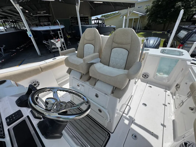 Slide: The Image of 2022 Sea Fox 288 Commander boat interior with dual captain's chairs and steering wheel. - 35