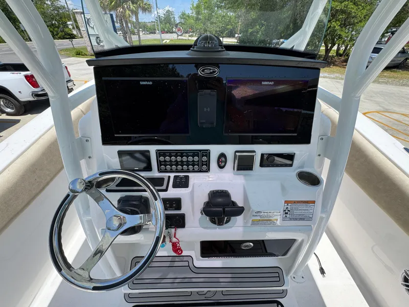 Slide: The Image of 2022 Sea Fox 288 Commander boat dashboard with steering wheel and navigation screens. - 38
