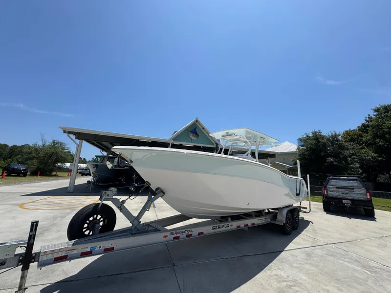Slide: The Image of 2022 Sea Fox 288 Commander boat on trailer under clear blue sky. - 4
