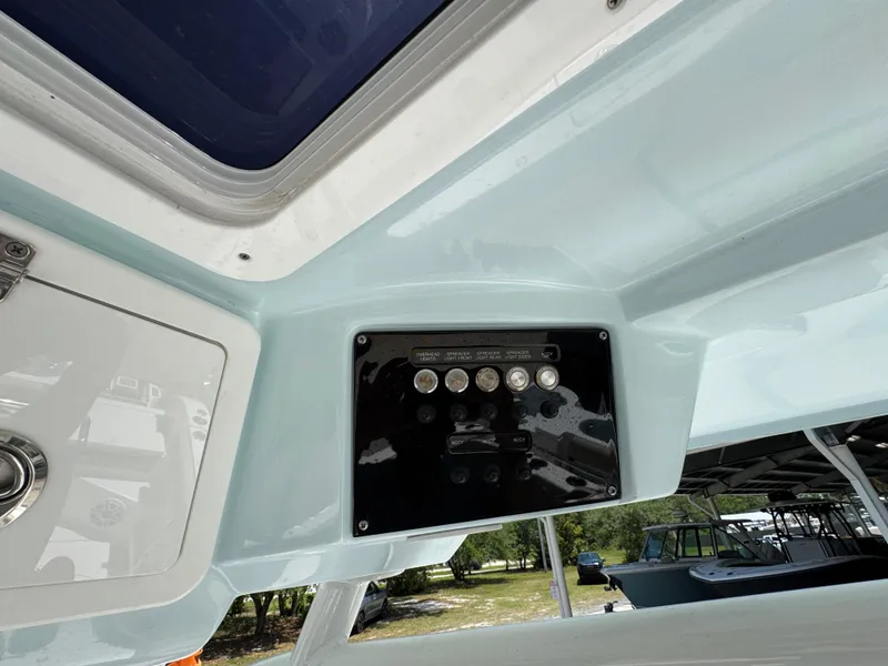 Slide: The Image of 2022 Sea Fox 288 Commander boat dashboard with control panel and switches. - 41