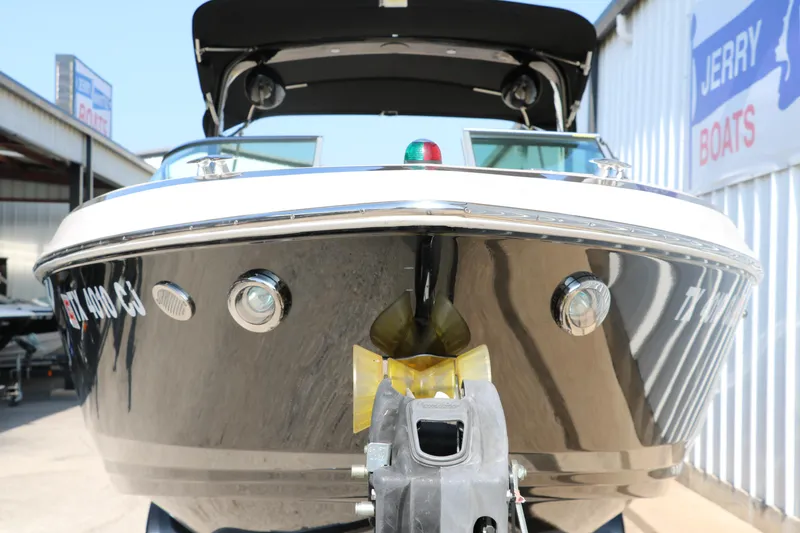 Slide: The Image of 2014 Regal 2500 RX Bowrider boat, front view, parked at a marina. - 10