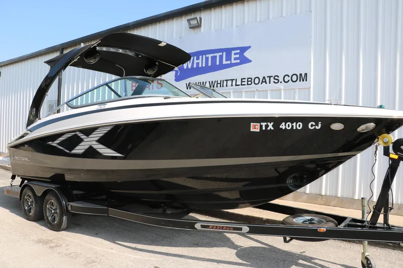 Slide: The Image of 2014 Regal 2500 RX Bowrider boat on trailer, parked outside Whittle Boats dealership. - 13