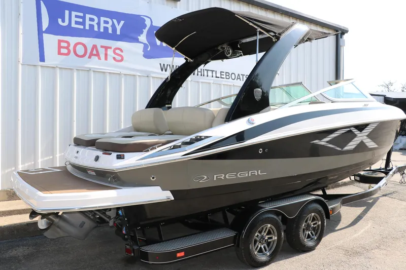 Slide: The Image of 2014 Regal 2500 RX Bowrider boat on trailer, displayed at Jerry Boats dealership. - 2