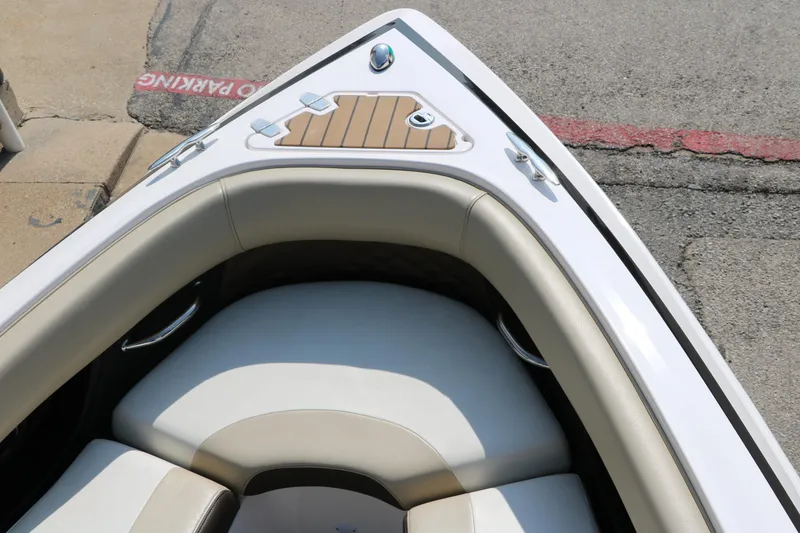 Slide: The Image of 2014 Regal 2500 RX Bowrider boat bow with cushioned seating and teak accents. - 24