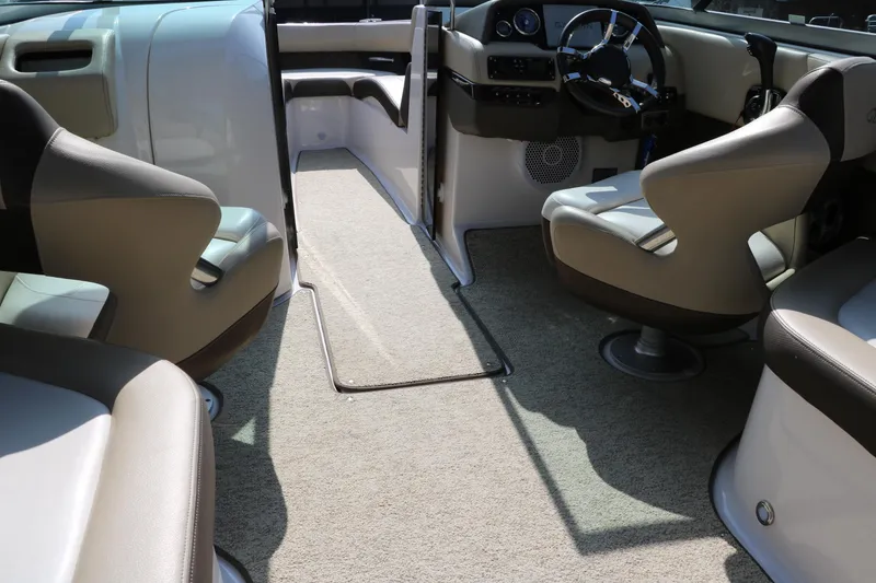 Slide: The Image of 2014 Regal 2500 RX Bowrider interior with beige seating and steering console. - 26