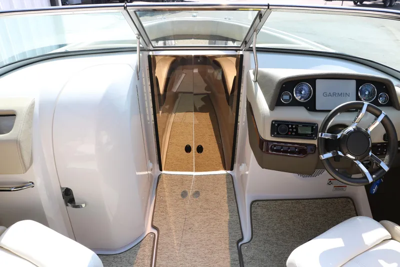 Slide: The Image of 2014 Regal 2500 RX Bowrider cockpit with Garmin navigation, sleek design, and modern controls. - 27
