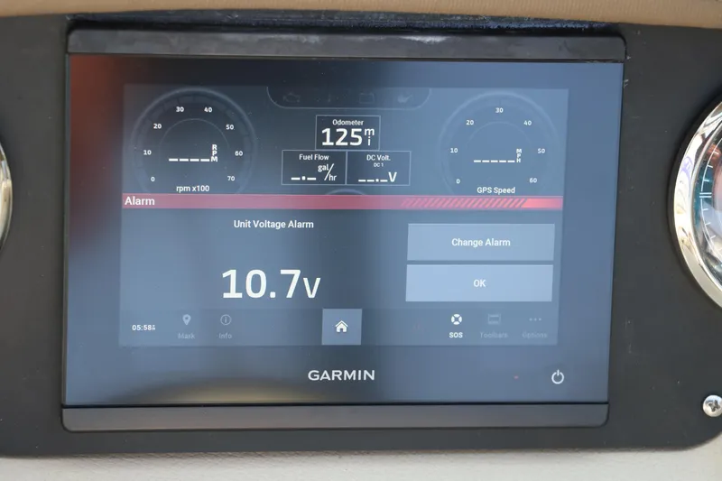 Slide: The Image of Garmin display showing voltage alarm on 2014 Regal 2500 RX Bowrider dashboard. - 29