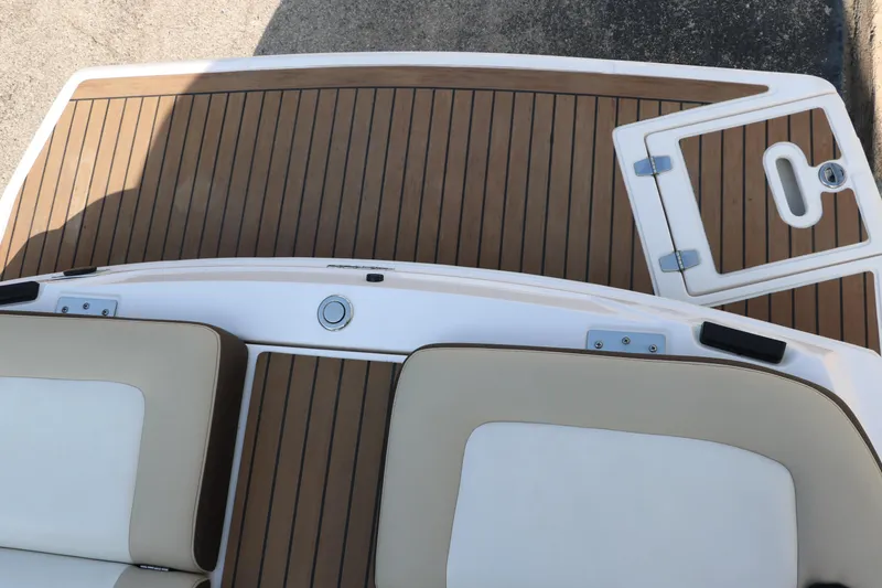Slide: The Image of 2014 Regal 2500 RX Bowrider boat deck with teak flooring and cushioned seating. - 35