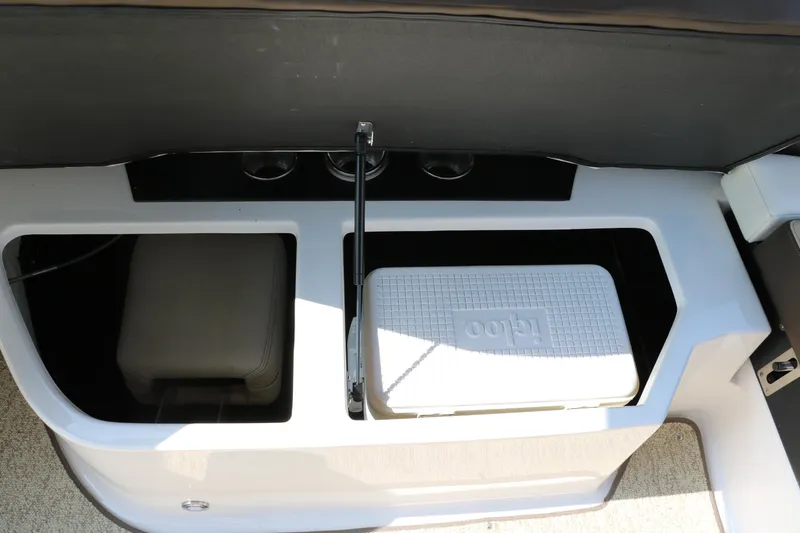 Slide: The Image of 2014 Regal 2500 RX Bowrider storage compartment with cooler and seating area. - 42