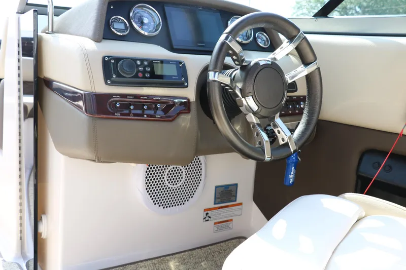 Slide: The Image of 2014 Regal 2500 RX Bowrider dashboard with steering wheel and control panel. - 46