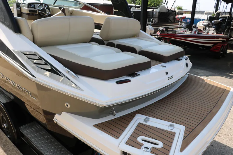 Slide: The Image of 2014 Regal 2500 RX Bowrider with spacious seating and sleek design in a marina setting. - 7