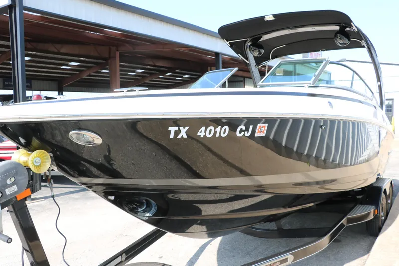 Slide: The Image of 2014 Regal 2500 RX Bowrider boat on trailer, side view, black and white exterior. - 9