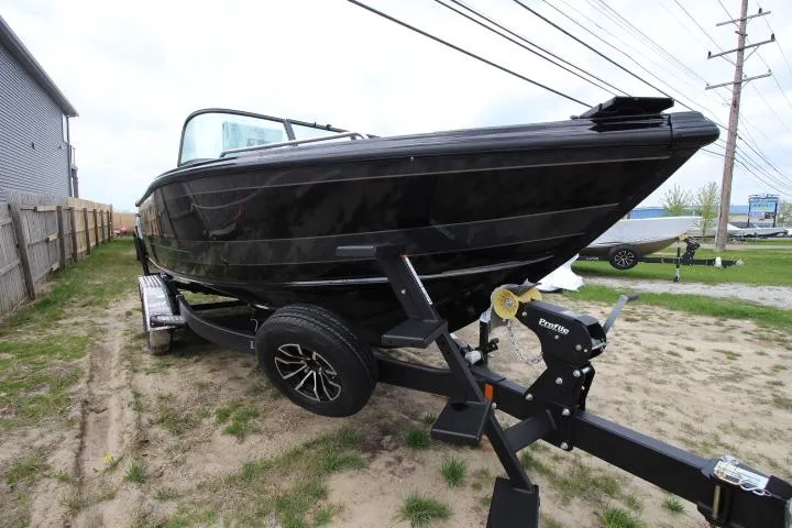 Slide: The Image of 2025 Lund 2075 Tyee boat on trailer, black exterior, parked outdoors. - 1