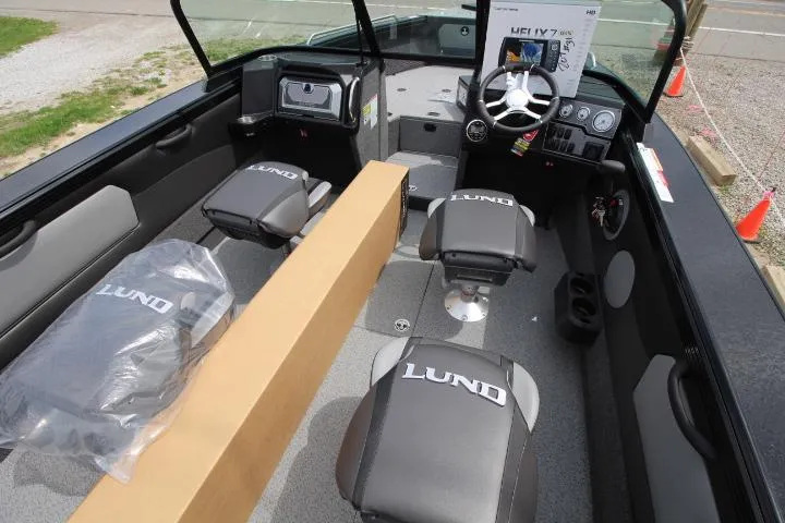 Slide: The Image of 2025 Lund 2075 Tyee boat interior with branded seats and modern dashboard. - 3