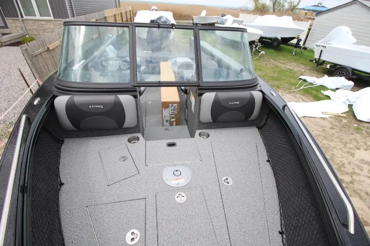 Slide: The Image of 2025 Lund 2075 Tyee boat interior with spacious seating and storage compartments. - 8