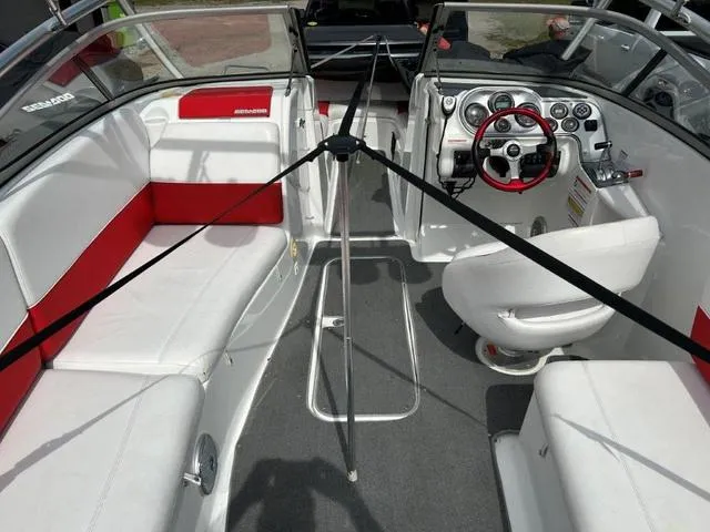 Slide: The Image of 2008 BRP Sea Doo WAKE 230 Jetboat interior with red and white seating, steering wheel, and dashboard. - 10