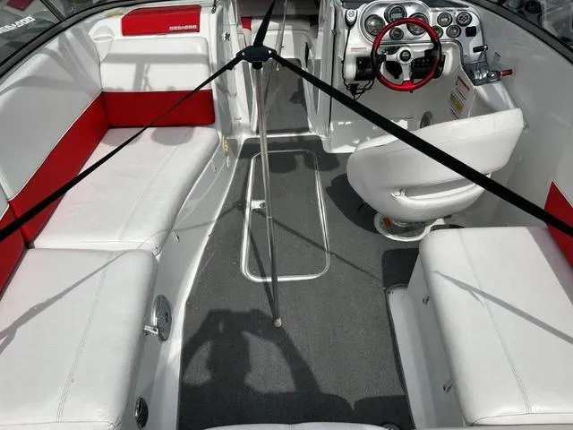Slide: The Image of 2008 BRP Sea Doo WAKE 230 Jetboat interior with white and red seating, steering wheel, and controls. - 11