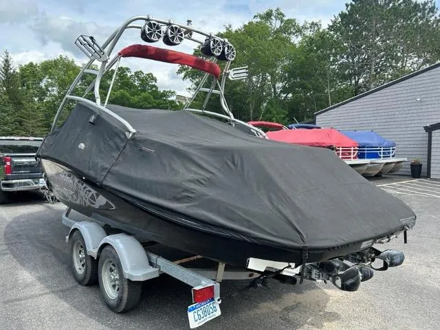 Slide: The Image of 2008 BRP Sea Doo WAKE 230 Jetboat Twin covered on trailer, parked outdoors. - 3