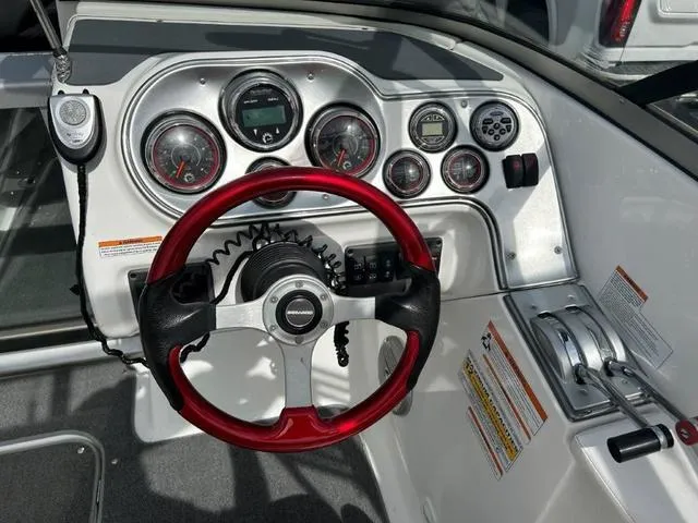 Slide: The Image of 2008 BRP Sea Doo WAKE 230 Jetboat dashboard with red steering wheel and gauges. - 5
