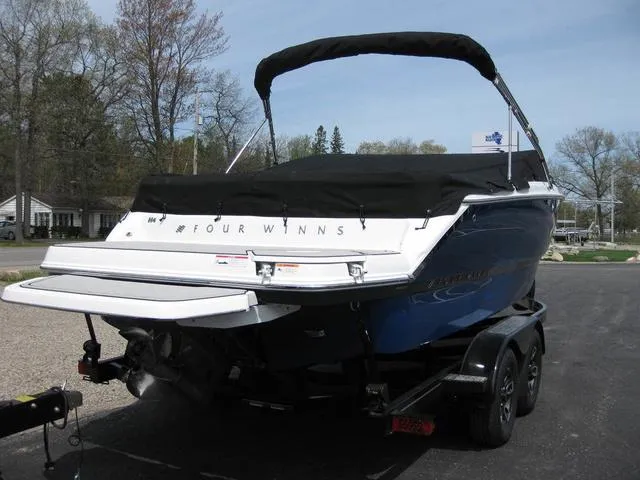 Slide: The Image of 2023 Four Winns H4 boat on trailer, covered and parked outdoors. - 3