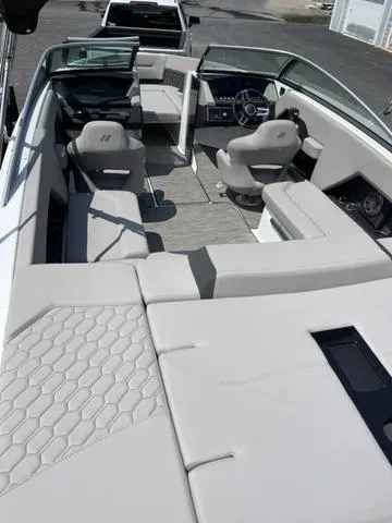 Slide: The Image of 2023 Four Winns H4 boat interior with modern seating and steering console. - 4