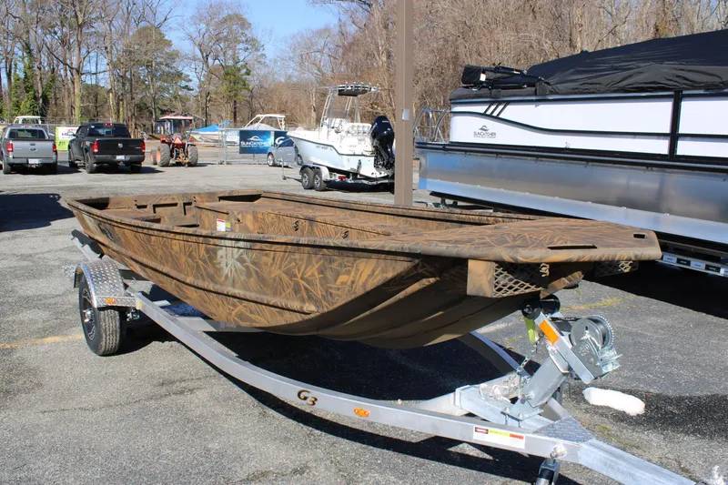 The Image of 2025 G3 Gator Tough 15 DK boat with camouflage design on display in showroom. - 0