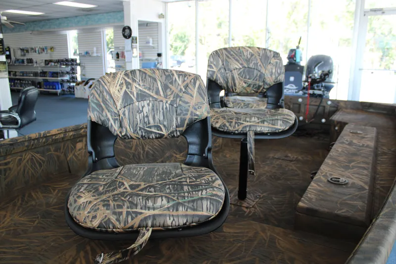 Slide: The Image of 2025 G3 Gator Tough 15 DK boat with camo seats in showroom. - 10