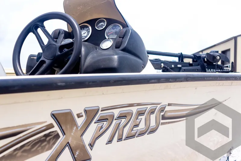 Slide: The Image of 2008 Xpress HD18SCA boat dashboard with steering wheel and gauges. - 11