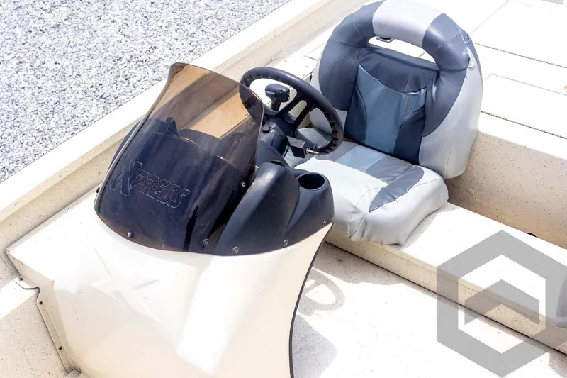 Slide: The Image of 2008 Xpress HD18SCA boat console and seat with steering wheel and windshield. - 16