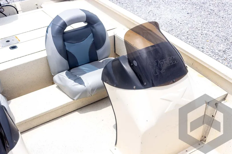 Slide: The Image of 2008 Xpress HD18SCA boat interior with seat and console, featuring a windshield. - 17