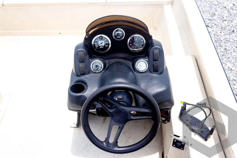 Slide: The Image of Steering console of 2008 Xpress HD18SCA boat with gauges and controls. - 18