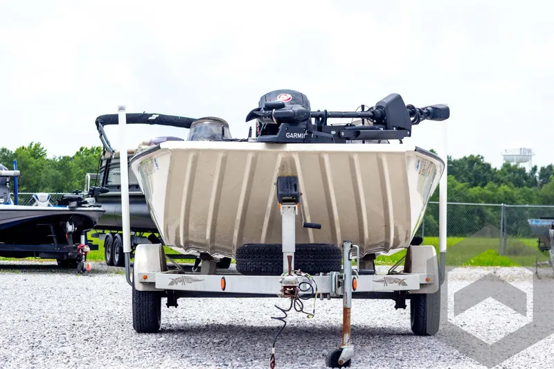 Slide: The Image of 2008 Xpress HD18SCA boat on trailer, parked outdoors on gravel. - 2