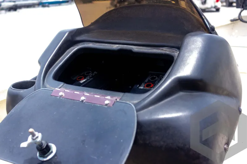 Slide: The Image of Open storage compartment of 2008 Xpress HD18SCA boat with visible battery setup. - 23