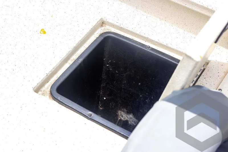 Slide: The Image of Storage compartment on 2008 Xpress HD18SCA boat, featuring a black interior. - 29