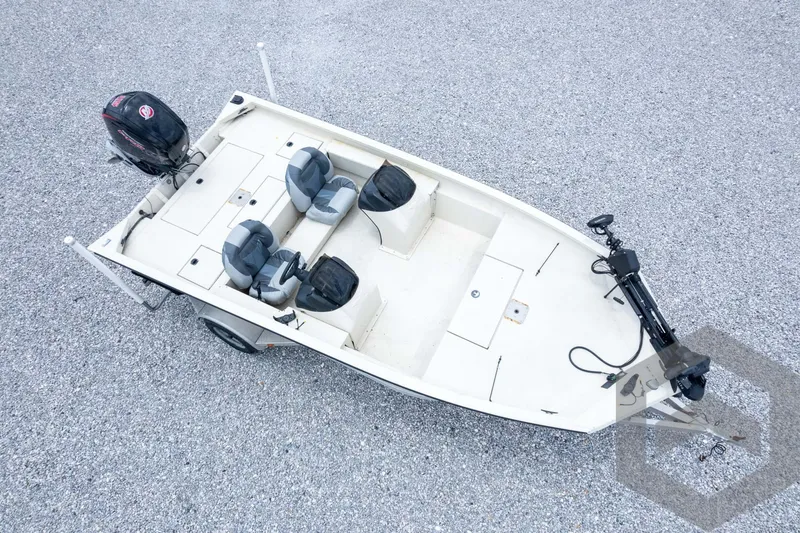 Slide: The Image of 2008 Xpress HD18SCA boat on gravel, featuring dual seats and outboard motor. - 38