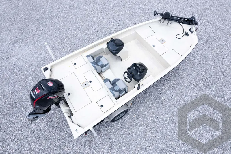 Slide: The Image of 2008 Xpress HD18SCA boat with motor, steering console, and seating on gravel surface. - 40