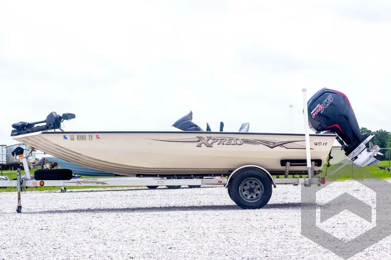Slide: The Image of 2008 Xpress HD18SCA boat on trailer with outboard motor, parked on gravel. - 7