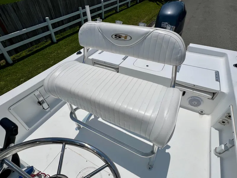 Slide: The Image of 2010 Sea Hunt BX22 Pro boat with white seating and steering wheel. - 10