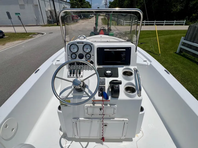 Slide: The Image of 2010 Sea Hunt BX22 Pro boat console with steering wheel and gauges. - 11