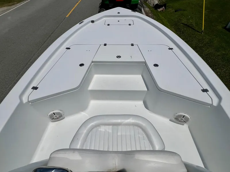 Slide: The Image of 2010 Sea Hunt BX22 Pro boat deck with storage compartments and seating. - 13
