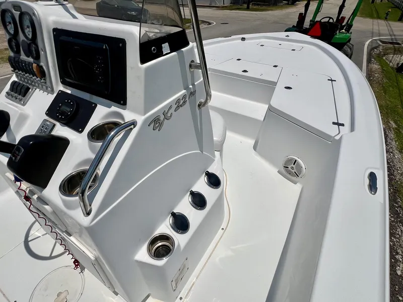 Slide: The Image of 2010 Sea Hunt BX22 Pro boat interior with control panel and seating area. - 14