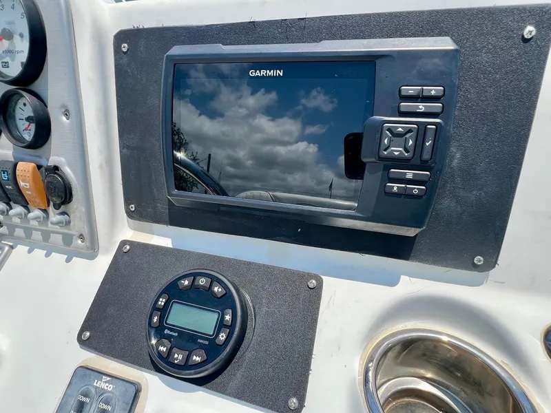 Slide: The Image of Garmin navigation system on 2010 Sea Hunt BX22 Pro boat dashboard with gauges. - 16