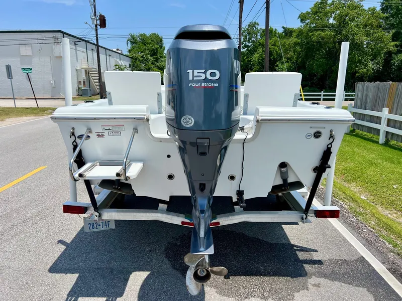 Slide: The Image of 2010 Sea Hunt BX22 Pro boat with 150 horsepower outboard motor on trailer. - 3