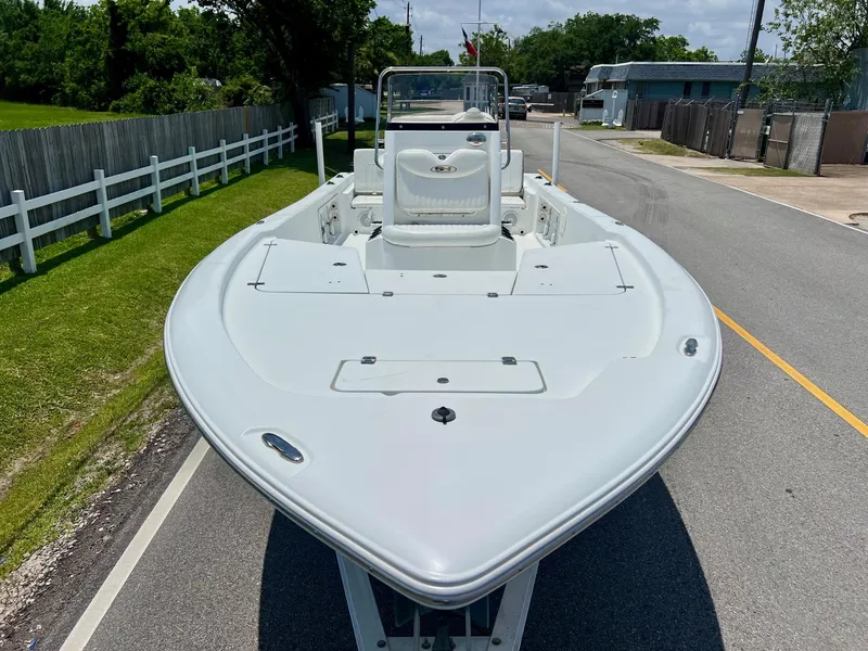 Slide: The Image of 2010 Sea Hunt BX22 Pro boat on trailer, parked on a suburban street. - 6