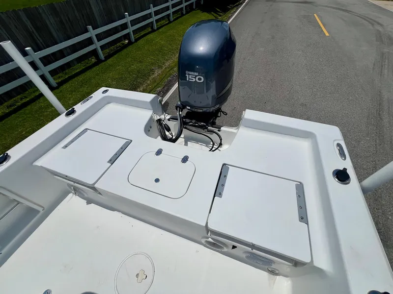 Slide: The Image of 2010 Sea Hunt BX22 Pro boat with Yamaha 150 engine, parked on a road. - 8
