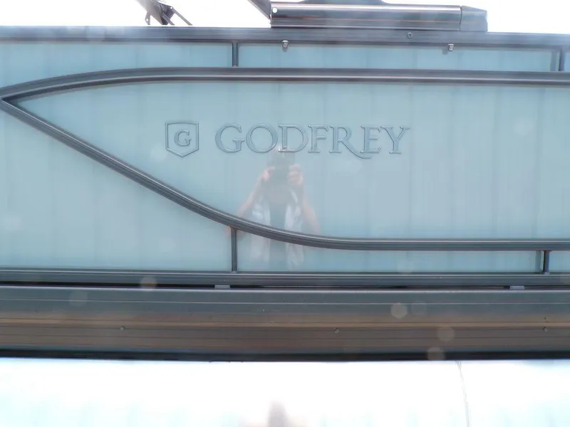 Slide: The Image of 2025 Godfrey Sweetwater 2286 SFL pontoon boat with logo detail. - 2