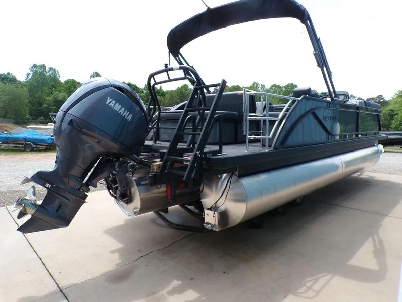 Slide: The Image of 2025 Godfrey Sweetwater 2286 SFL pontoon boat with Yamaha outboard motor, docked outdoors. - 3