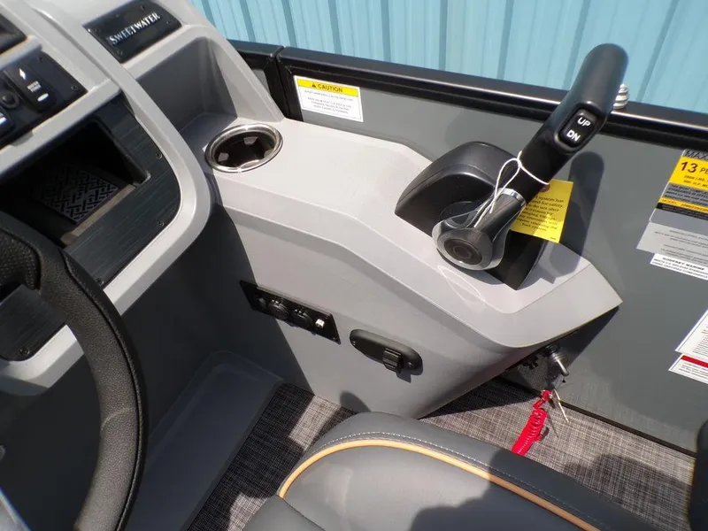 Slide: The Image of Control console of 2025 Godfrey Sweetwater 2286 SFL boat with steering wheel and throttle. - 8
