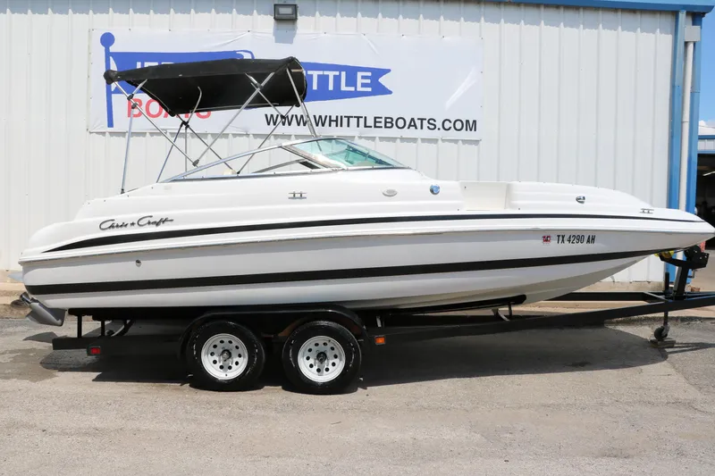Slide: The Image of 2000 Chris-Craft 232 boat on trailer, parked outside Whittle Boats dealership. - 17