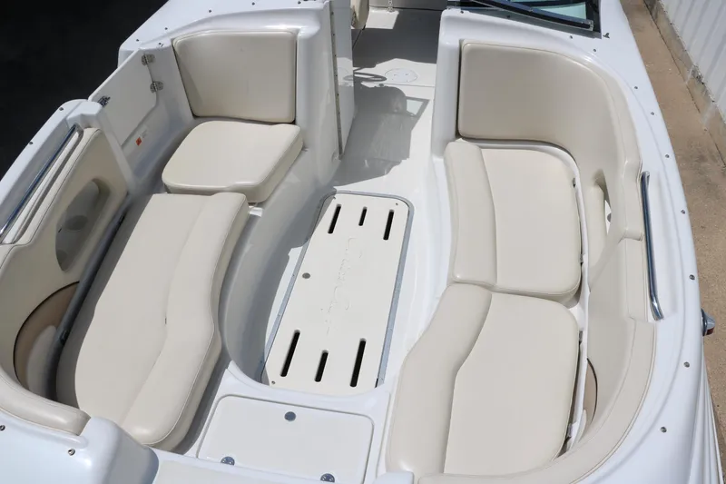 Slide: The Image of Interior view of 2000 Chris-Craft 232 boat with white seating and open windshield. - 22